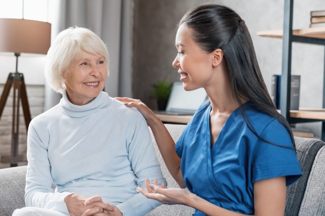 24 hour carers aiding an elderly woman at home